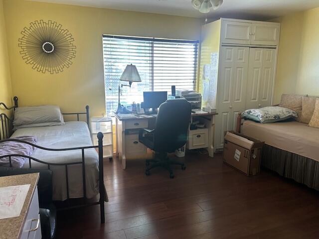 1910 SE Rainier Rd, Port Saint Lucie, FL 34952 - bedroom featuring a closet, dark wood finished floors, and an office area