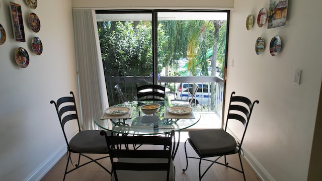 6864 Willow Wood Dr Unit 408, Boca Raton, FL 33434 - dining space with wood finished floors and healthy amount of natural light