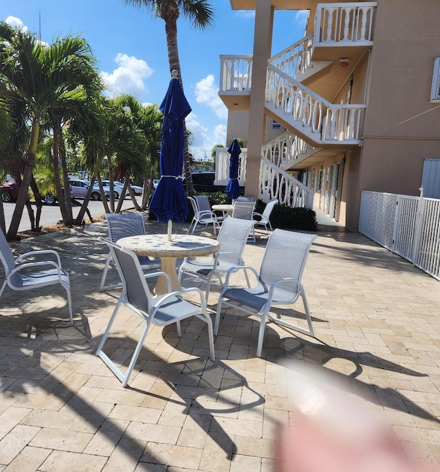 131 Doolen Ct Unit 302, North Palm Beach, FL 33408 - view of patio with stairway and outdoor dining area