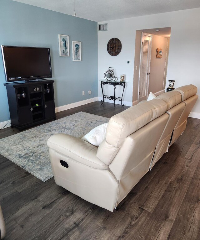 131 Doolen Ct Unit 302, North Palm Beach, FL 33408 - living area with dark wood-style floors and baseboards