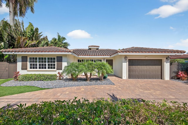 1921 W Terra Mar Dr, Lauderdale By The Sea, FL 33062 - view of front facade with an attached garage, stucco siding, driveway, and a tile roof