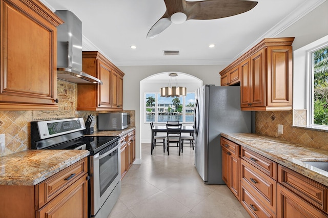 1921 W Terra Mar Dr, Lauderdale By The Sea, FL 33062 - kitchen featuring appliances with stainless steel finishes, wall chimney exhaust hood, crown molding, ceiling fan, and arched walkways