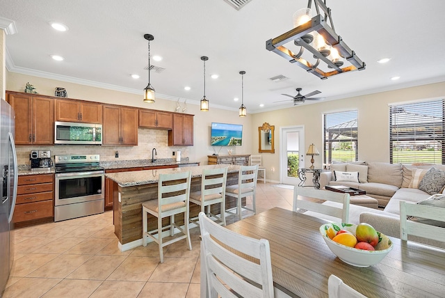 2366 Byron St, Palm Springs, FL 33406 - kitchen featuring appliances with stainless steel finishes, light tile patterned flooring, backsplash, brown cabinets, and ornamental molding