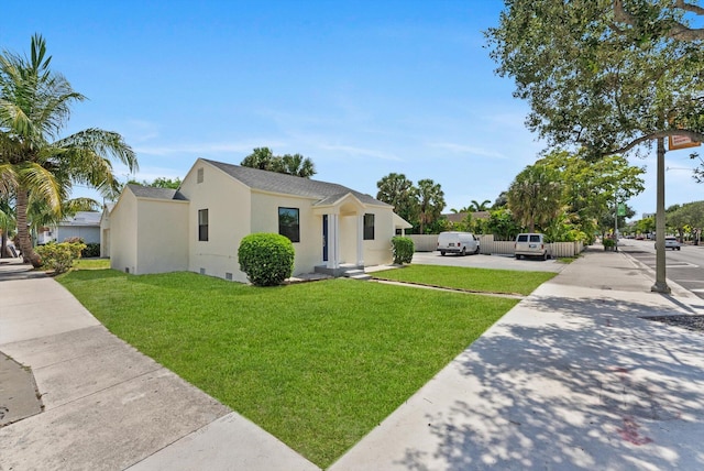 1420 Lake Ave, Lake Worth Beach, FL 33460 - single story home with stucco siding, a front lawn, driveway, and a shingled roof