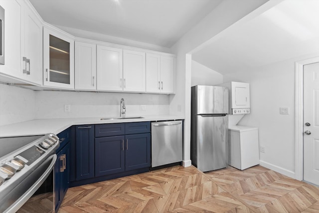 1420 Lake Ave, Lake Worth Beach, FL 33460 - kitchen with appliances with stainless steel finishes, blue cabinets, white cabinets, glass insert cabinets, and light countertops