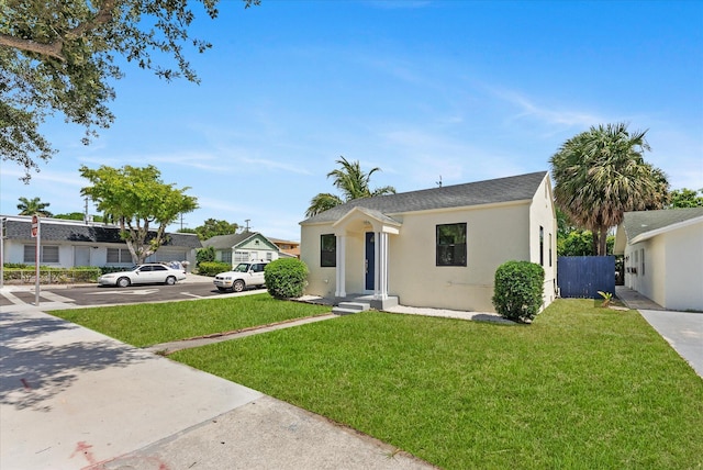 1420 Lake Ave, Lake Worth Beach, FL 33460 - view of front of house with stucco siding and roof with shingles