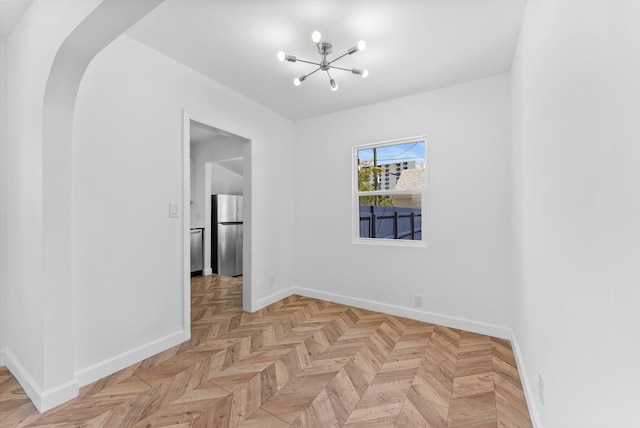 1420 Lake Ave, Lake Worth Beach, FL 33460 - empty room featuring a chandelier and baseboards