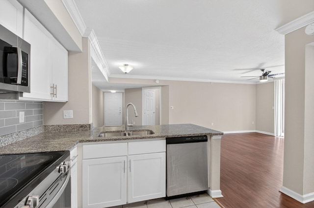 15035 Michelangelo Blvd Unit 105, Delray Beach, FL 33446 - kitchen featuring appliances with stainless steel finishes, crown molding, a peninsula, ceiling fan, and white cabinetry
