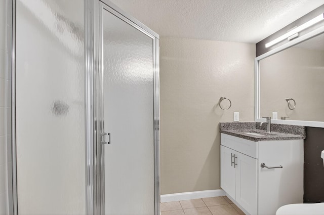 15035 Michelangelo Blvd Unit 105, Delray Beach, FL 33446 - full bathroom with a stall shower, vanity, tile patterned flooring, and a textured ceiling