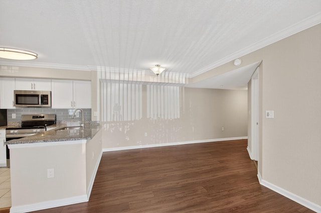 15035 Michelangelo Blvd Unit 105, Delray Beach, FL 33446 - kitchen with stainless steel appliances, crown molding, white cabinetry, light stone countertops, and decorative backsplash