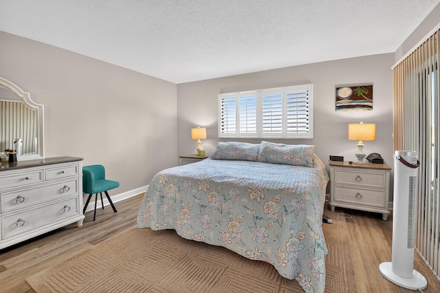 14425 Strathmore Ln Unit 404, Delray Beach, FL 33446 - bedroom featuring wood finished floors and a textured ceiling