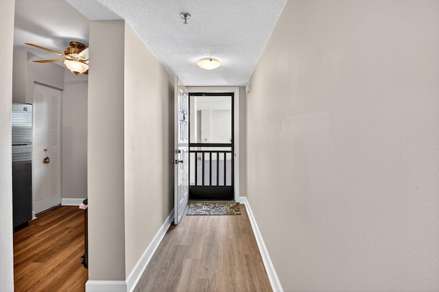 14425 Strathmore Ln Unit 404, Delray Beach, FL 33446 - hall featuring wood finished floors and a textured ceiling