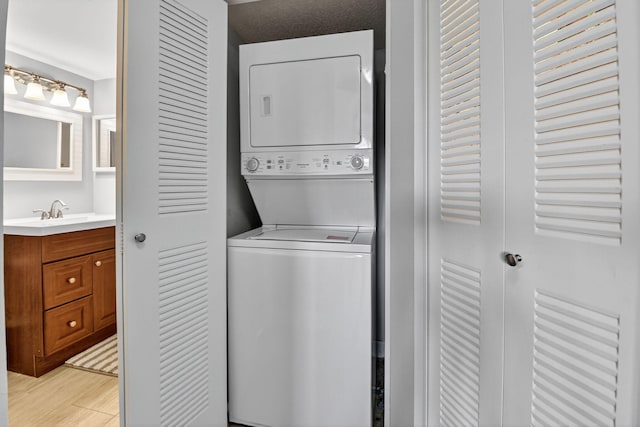 14425 Strathmore Ln Unit 404, Delray Beach, FL 33446 - laundry room with stacked washer / drying machine and light wood-type flooring