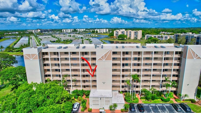 14425 Strathmore Ln Unit 404, Delray Beach, FL 33446 - view of apartment building / complex featuring a water view and uncovered parking