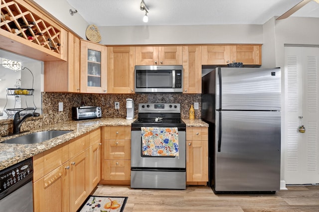 14425 Strathmore Ln Unit 404, Delray Beach, FL 33446 - kitchen featuring stainless steel appliances, light brown cabinetry, tasteful backsplash, and light wood-style floors