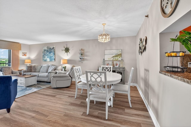 14425 Strathmore Ln Unit 404, Delray Beach, FL 33446 - dining area with light wood-style floors and a chandelier