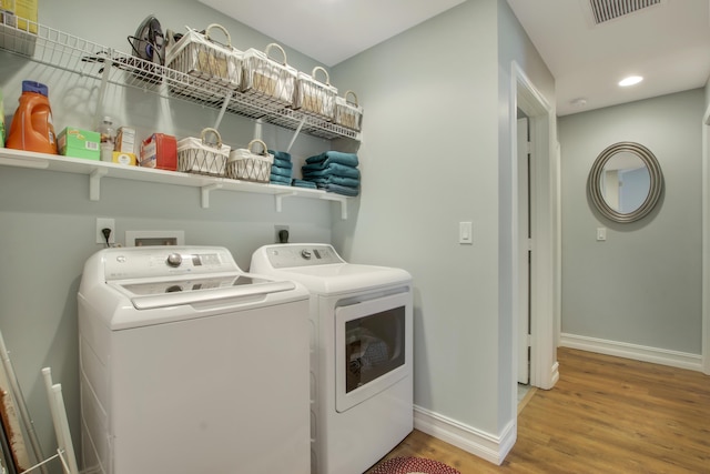 9155 SE Athena St, Hobe Sound, FL 33455 - laundry area featuring separate washer and dryer, wood finished floors, and recessed lighting