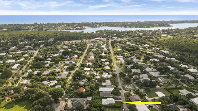 9155 SE Athena St, Hobe Sound, FL 33455 - aerial view of property and surrounding area with nearby suburban area and a large body of water