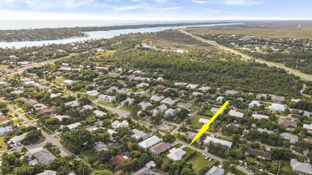 9155 SE Athena St, Hobe Sound, FL 33455 - aerial view of property and surrounding area with a large body of water and nearby suburban area