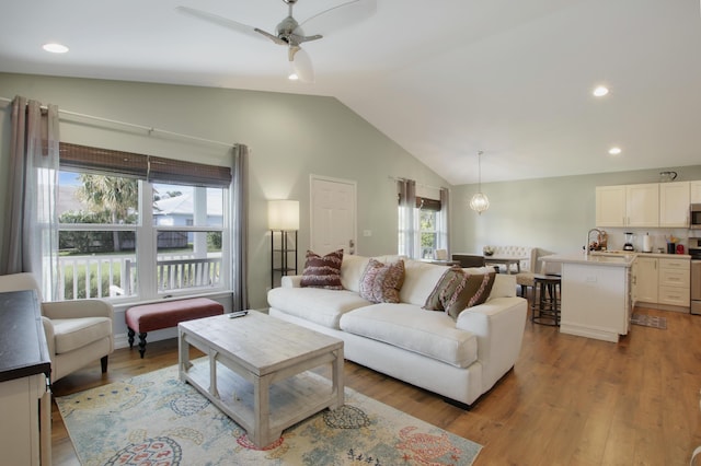 9155 SE Athena St, Hobe Sound, FL 33455 - living area with lofted ceiling, wood finished floors, ceiling fan, and recessed lighting