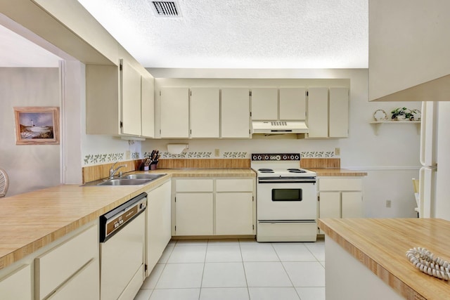 1600 SE Saint Lucie Blvd SE Unit 211, Stuart, FL 34996 - kitchen with white appliances, custom exhaust hood, light countertops, light tile patterned floors, and a textured ceiling