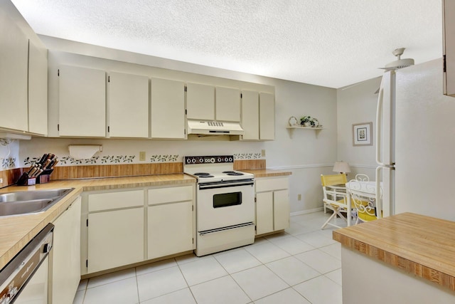 1600 SE Saint Lucie Blvd SE Unit 211, Stuart, FL 34996 - kitchen featuring white appliances, custom exhaust hood, a textured ceiling, light countertops, and light tile patterned floors