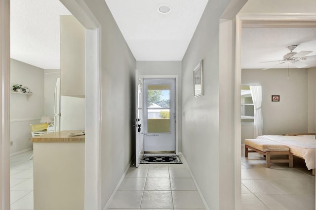 1600 SE Saint Lucie Blvd SE Unit 211, Stuart, FL 34996 - hall with light tile patterned floors and baseboards