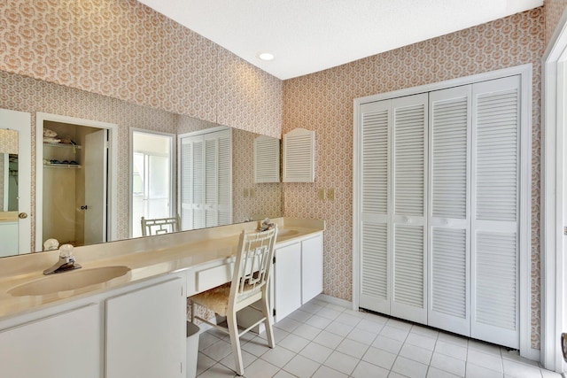 1600 SE Saint Lucie Blvd SE Unit 211, Stuart, FL 34996 - bathroom featuring a closet, wallpapered walls, tile patterned floors, vanity, and a bath