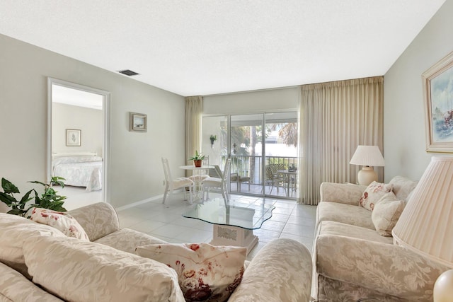 1600 SE Saint Lucie Blvd SE Unit 211, Stuart, FL 34996 - living area featuring light tile patterned floors and a textured ceiling