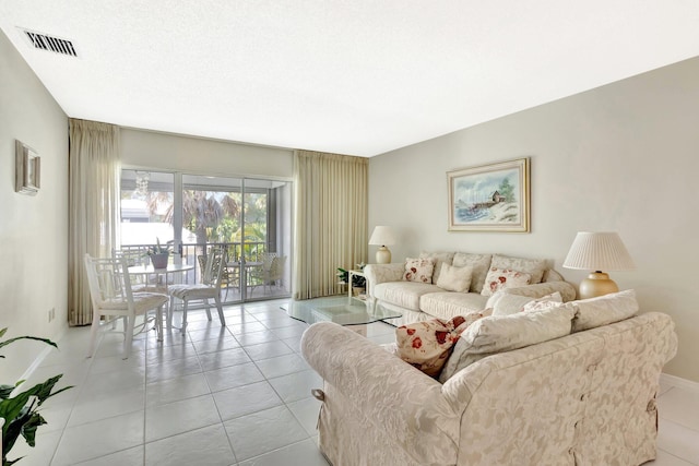 1600 SE Saint Lucie Blvd SE Unit 211, Stuart, FL 34996 - living room featuring baseboards and light tile patterned floors