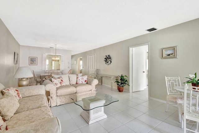 1600 SE Saint Lucie Blvd SE Unit 211, Stuart, FL 34996 - living room featuring a chandelier and light tile patterned floors