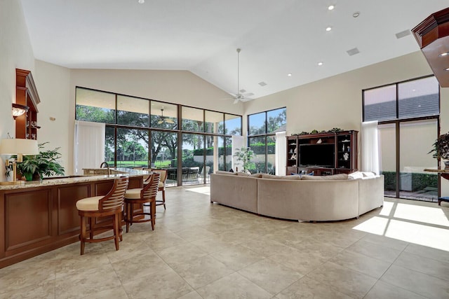 13308 Verdun Dr, Palm Beach Gardens, FL 33410 - living area with plenty of natural light, ceiling fan, light tile patterned floors, and high vaulted ceiling
