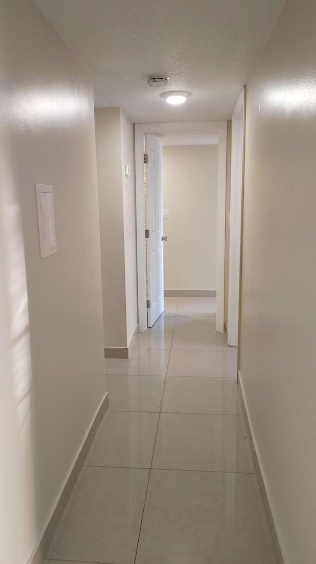 3710 NW 21st St Unit 214, Lauderdale Lakes, FL 33311 - corridor with light tile patterned floors and a textured ceiling