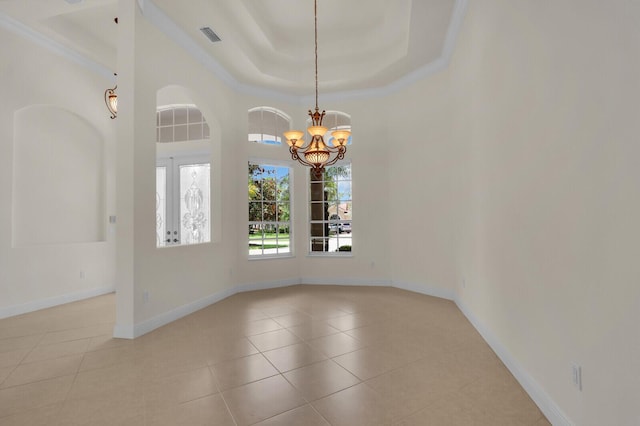 8732 Bally Bunion Rd, Port Saint Lucie, FL 34986 - spare room with a chandelier, a raised ceiling, and light tile patterned floors