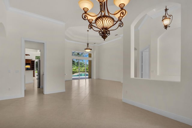 8732 Bally Bunion Rd, Port Saint Lucie, FL 34986 - tiled empty room featuring a chandelier, arched walkways, crown molding, a high ceiling, and a tray ceiling