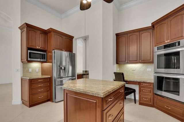 8732 Bally Bunion Rd, Port Saint Lucie, FL 34986 - kitchen with stainless steel appliances, crown molding, light stone countertops, and tasteful backsplash