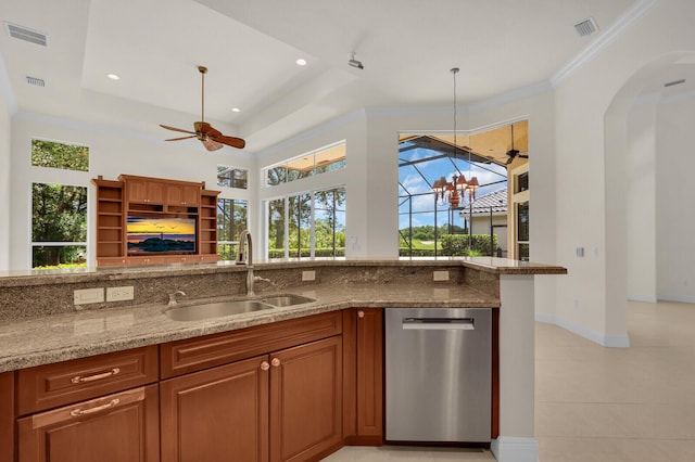 8732 Bally Bunion Rd, Port Saint Lucie, FL 34986 - kitchen with dishwasher, light stone counters, decorative light fixtures, brown cabinetry, and ceiling fan
