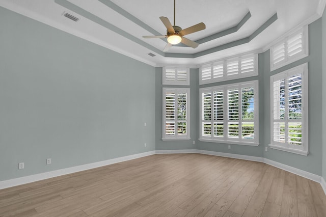 8732 Bally Bunion Rd, Port Saint Lucie, FL 34986 - spare room featuring ceiling fan, a raised ceiling, and light wood-style floors