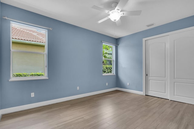 8732 Bally Bunion Rd, Port Saint Lucie, FL 34986 - unfurnished bedroom featuring wood finished floors, a closet, and a ceiling fan