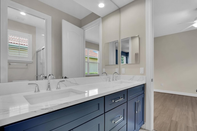 8732 Bally Bunion Rd, Port Saint Lucie, FL 34986 - full bathroom with double vanity, wood finished floors, plenty of natural light, a ceiling fan, and recessed lighting