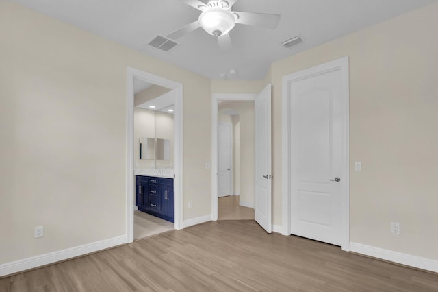 8732 Bally Bunion Rd, Port Saint Lucie, FL 34986 - unfurnished bedroom with light wood-style floors, ensuite bathroom, and a ceiling fan