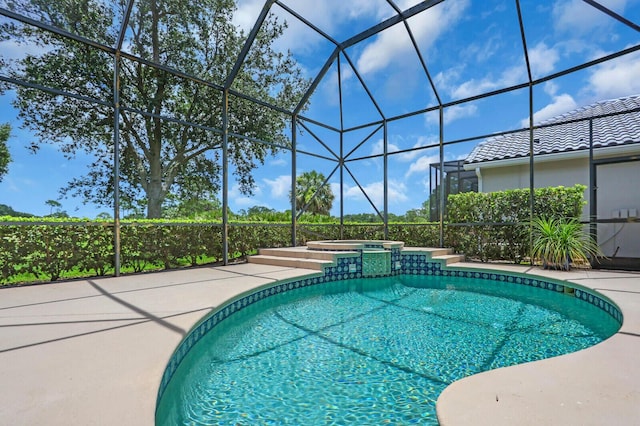 8732 Bally Bunion Rd, Port Saint Lucie, FL 34986 - view of pool featuring a lanai, a patio area, and a pool with connected hot tub