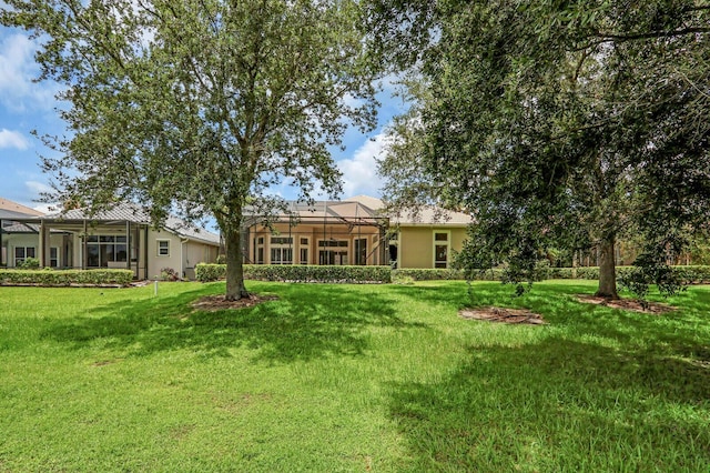 8732 Bally Bunion Rd, Port Saint Lucie, FL 34986 - view of grassy yard with glass enclosure