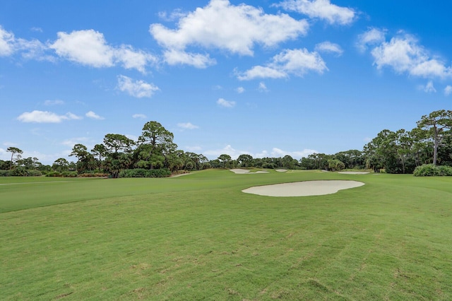 8732 Bally Bunion Rd, Port Saint Lucie, FL 34986 - view of home's community with golf course view, a lawn, and view of wooded area