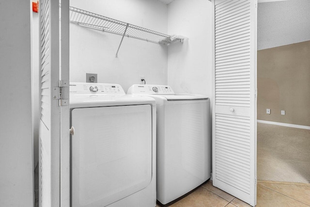 1000 Crystal Way Unit J, Delray Beach, FL 33444 - laundry room featuring separate washer and dryer, light tile patterned floors, and light colored carpet