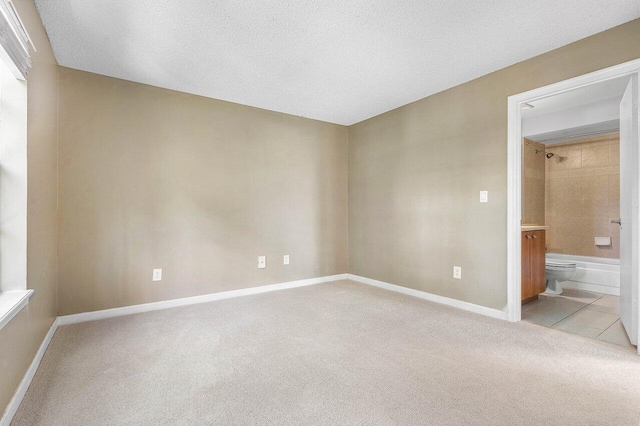 1000 Crystal Way Unit J, Delray Beach, FL 33444 - spare room with light carpet, light tile patterned floors, and a textured ceiling