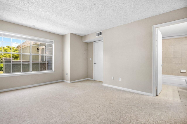 1000 Crystal Way Unit J, Delray Beach, FL 33444 - unfurnished bedroom with carpet, ensuite bathroom, and a textured ceiling