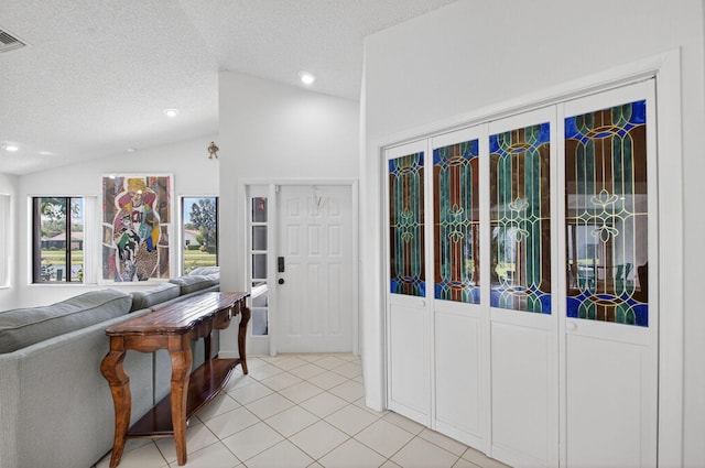3010 NW 12th St Unit D, Delray Beach, FL 33445 - living room featuring lofted ceiling, light tile patterned flooring, a textured ceiling, and recessed lighting