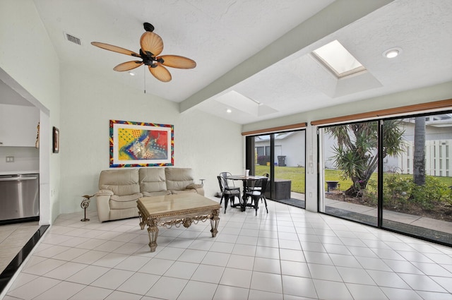 3010 NW 12th St Unit D, Delray Beach, FL 33445 - living area with vaulted ceiling, a skylight, a textured ceiling, light tile patterned flooring, and recessed lighting