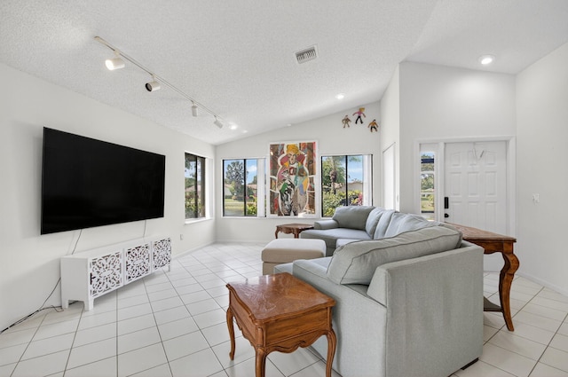 3010 NW 12th St Unit D, Delray Beach, FL 33445 - living area featuring light tile patterned flooring, lofted ceiling, a textured ceiling, track lighting, and recessed lighting